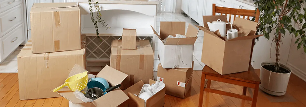 Packed moving boxes and household items in a kitchen before move-out or move-in cleaning, Atlanta, GA.